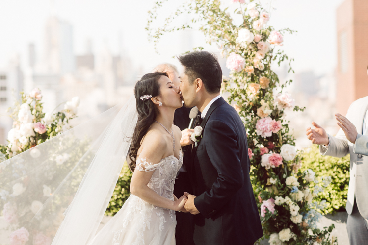 Public Hotel NYC spring rooftop wedding with Stella and Peter. NYC began to loosen COVID restrictions so events and weddings were finally allowed. Stella and Peter were able to keep their original wedding date, but unfortunately Stella's parents couldn't make it to the wedding due to COVID travel restrictions. Stella and Peter's wedding took place on 17th floor with rooftop access at the Public Hotel. Their wedding ceremony was on the rooftop, as well as their first look and some photos then we wandered around the hotel and took some epic photos at the pent house and escalator. Public Hotel NYC was so fun to photograph and I had the coolest, the most chill couple to work with. Stella and Peter's epic wedding at Public Hotel NYC photographed by Karis | Hey Karis.